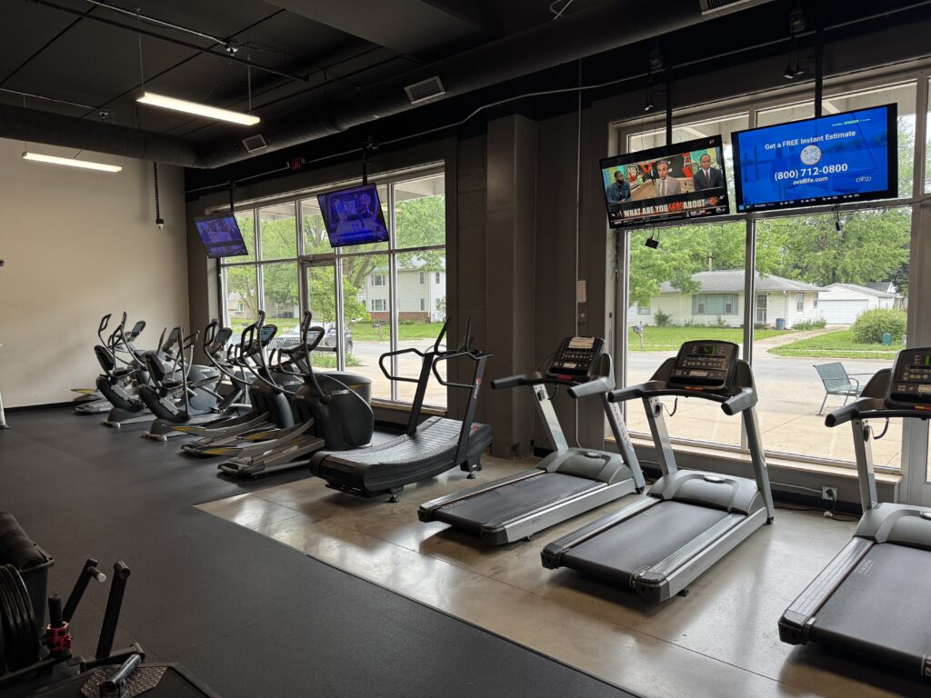 Treadmills, Bikes, Elliptical Machines, Stair Steppers, and Row Machine with TVs at Fifth Street Fitness Gym in Coralville, Iowa.